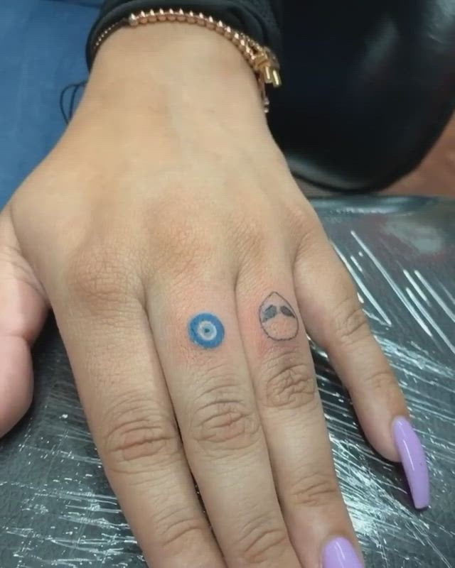 evil eye tattoo on finger