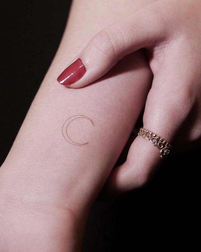 minimal crescent moon tattoo