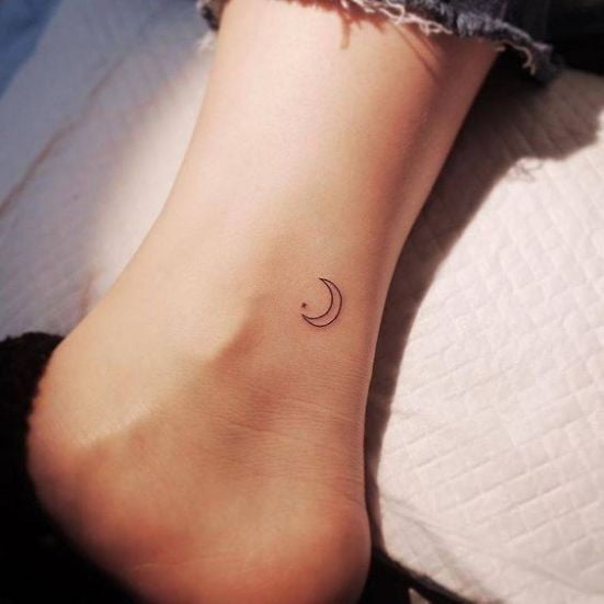minimalistic crescent moon tattoo ankle